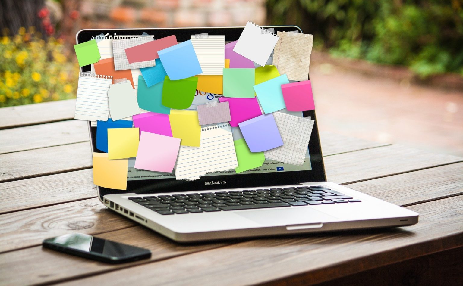 Sticky notes on laptop screen - Find A Facilitator